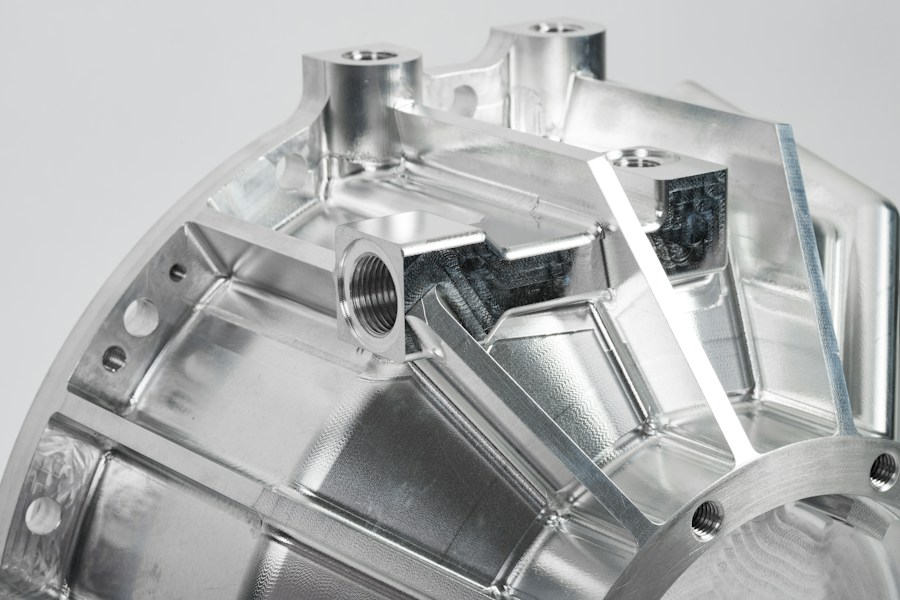 Complex precision machined metal component with curved pockets and bores