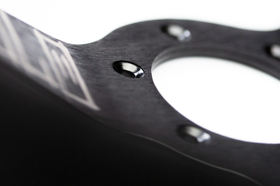 Dark metal component with machined edges