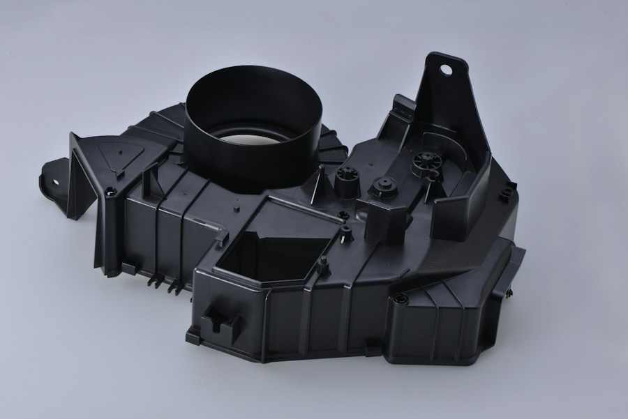 Black engineered component with precise features