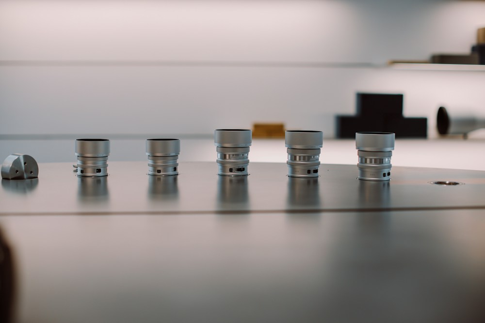 Organized row of identical machined metal production components